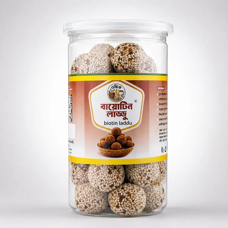 Shudhik Premium Biotin Laddu made with nuts and seeds, showcasing golden, textured biotin energy bites in a clear bowl.