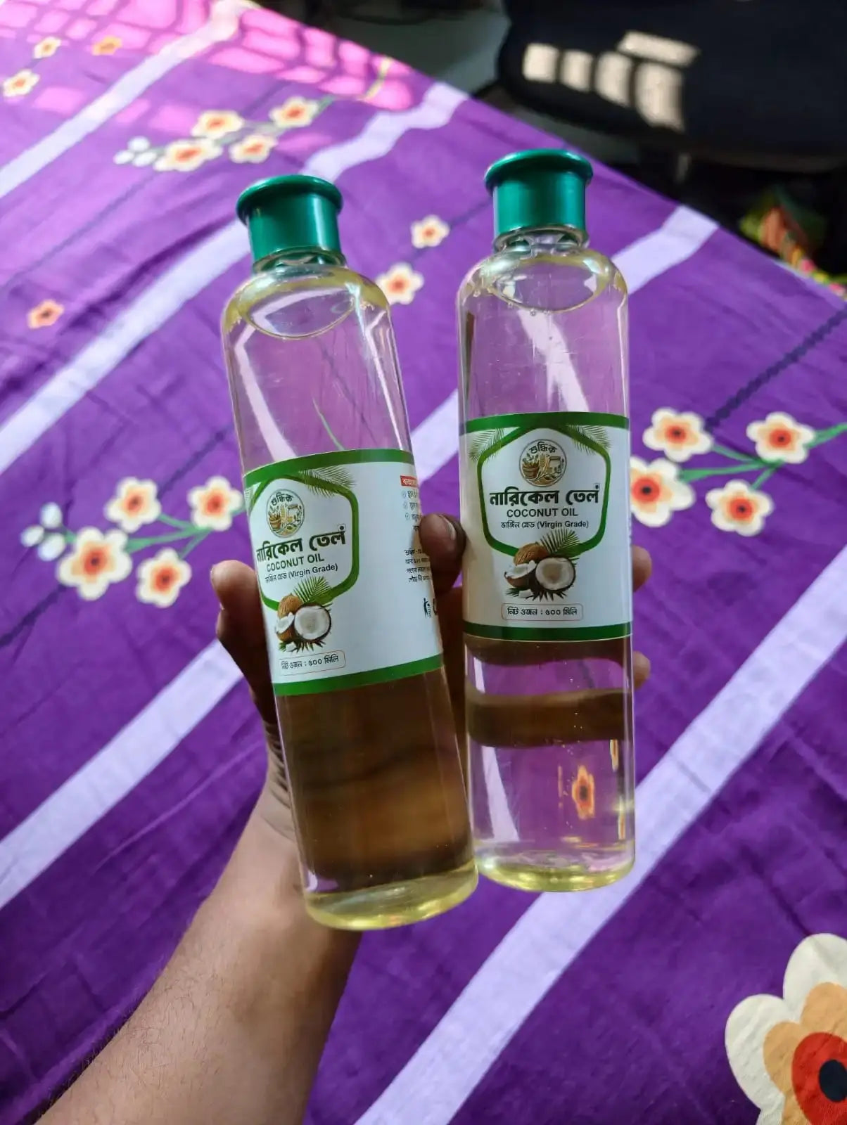 Shudhik extra-virgin coconut oil bottle for hair care, showcasing pure coconut oil in a clear container.