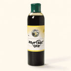 Shudhik black seed oil bottle showing the dark liquid inside, labeled as কালো জিরার তেল (Black Seed Oil) in Bangladesh.