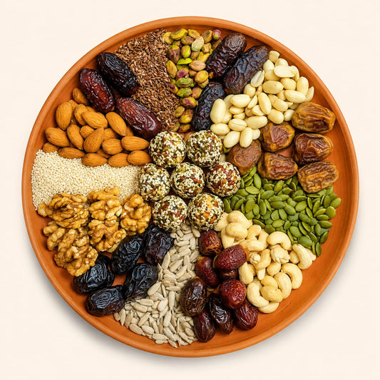 Assorted dried fruits and seeds on a terracotta platter, showcasing Shudhik Premium Biotin Laddu super food ingredients.