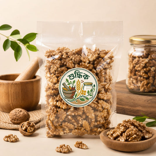 Shudhik premium akhrot (walnut) nut showing large, fresh walnuts with textured shells in a natural setting.