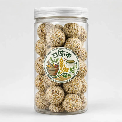 Shudhik Premium Biotin Laddu with sesame and nuts in a jar, showcasing golden-brown nut and seed-filled laddus.